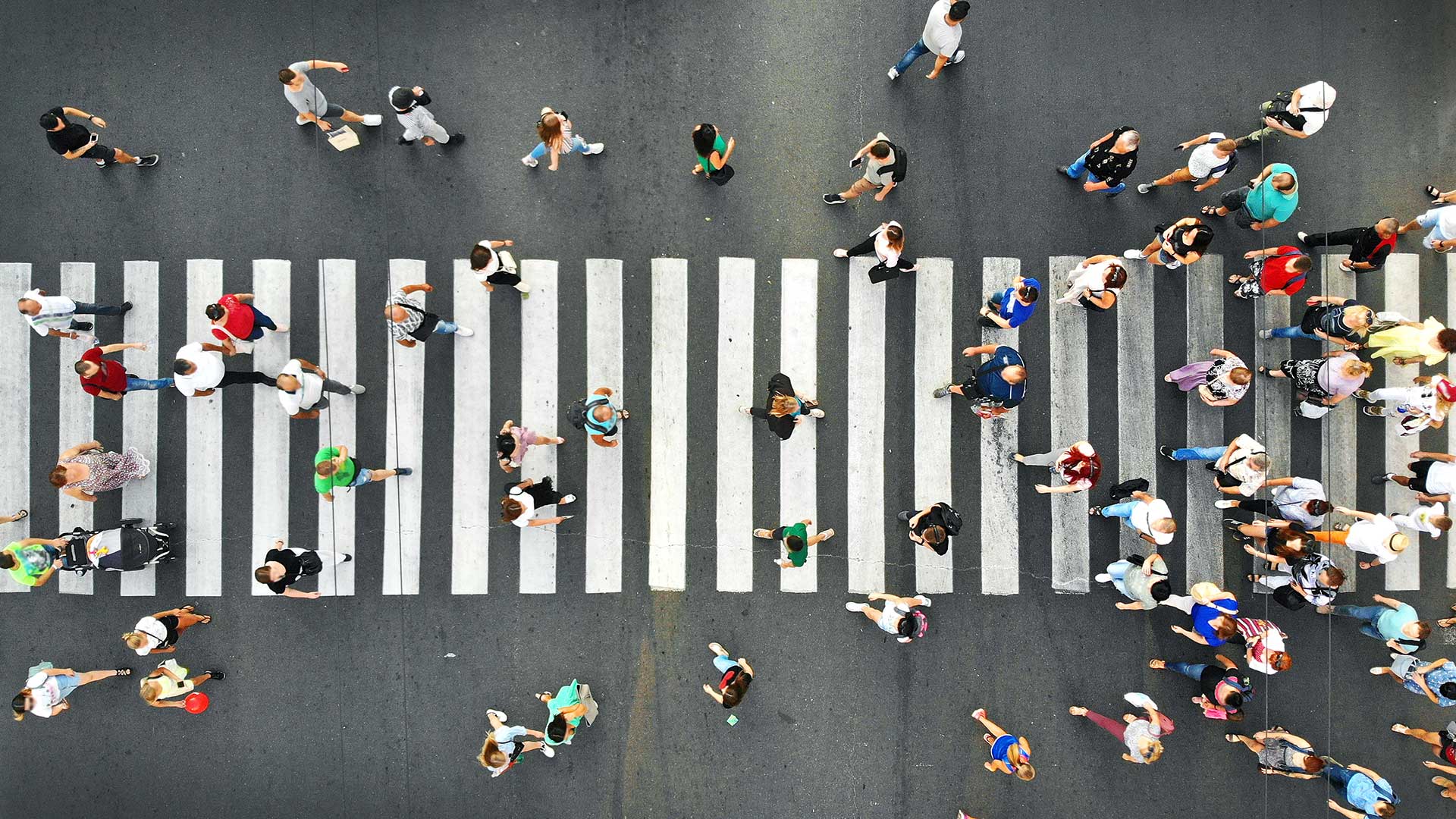 downward view of crowd crossing intersection