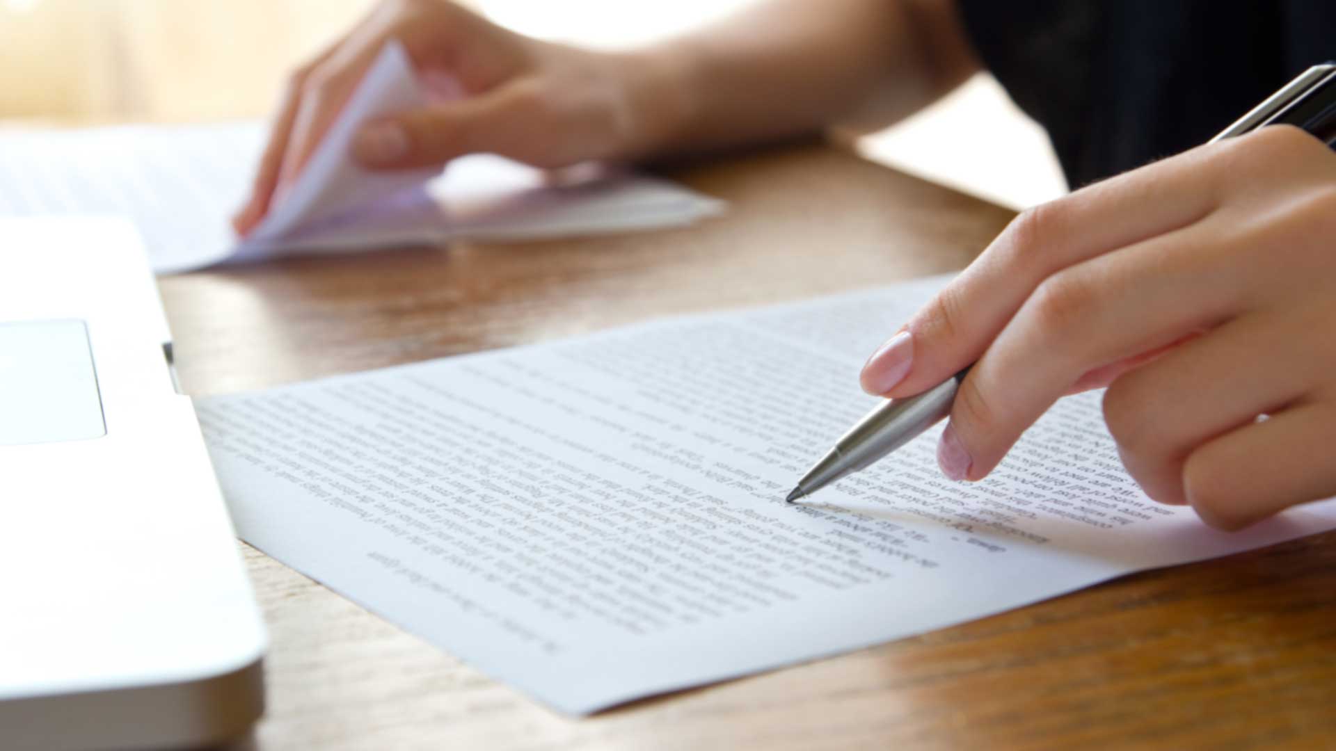 closeup of hands editing documents