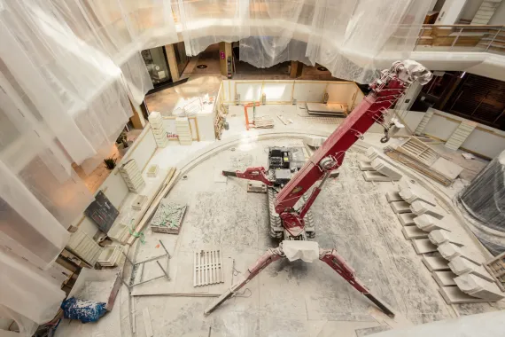 Construction inside a large two-story mall.