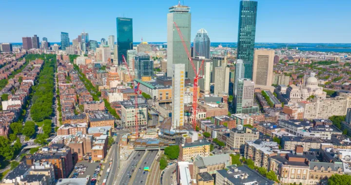 Cityscape view of buildings, roads, highways, and sea