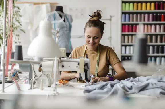A woman sitting at a sewing machine