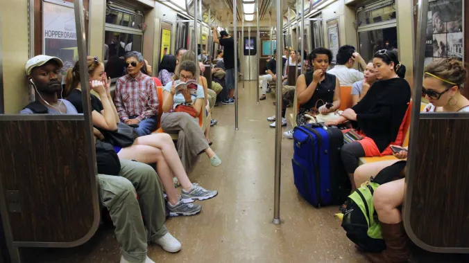 people sitting inside a New York subway car