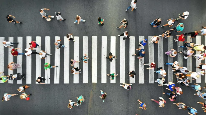 downward view of crowd crossing intersection