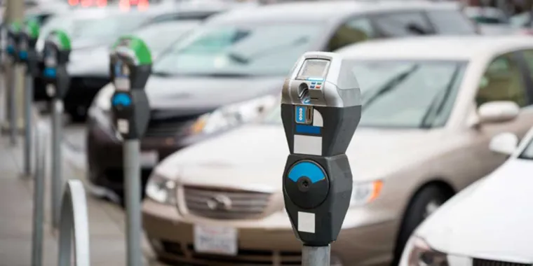 row of cars and parking meters