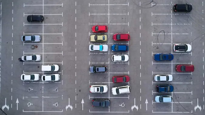 aerial view of a large outdoor parking lot with cars