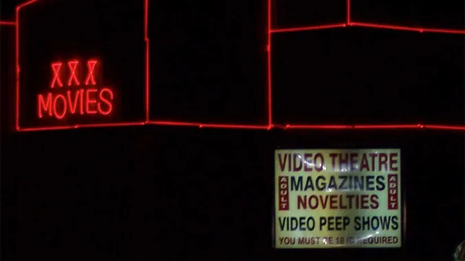 adult store exterior with neon signs