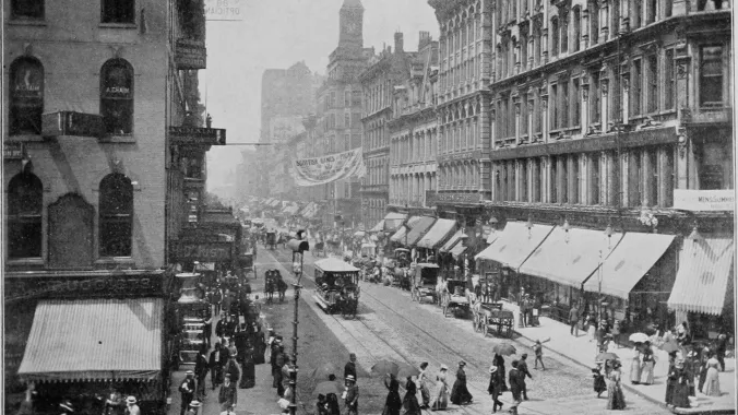 buildings, cars, people on Halsted Street in Chicago in 1900