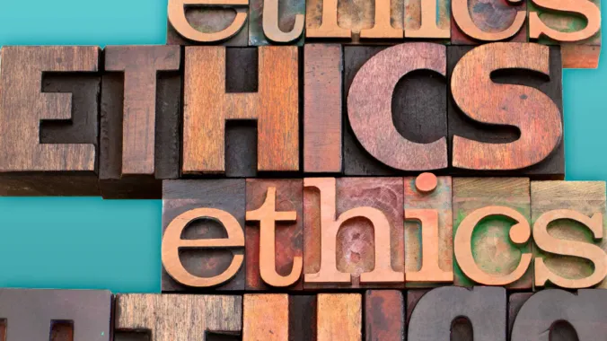 wood carved letters spelling out ethics