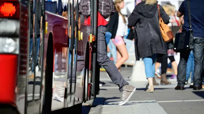 person getting on bus for urban planning course