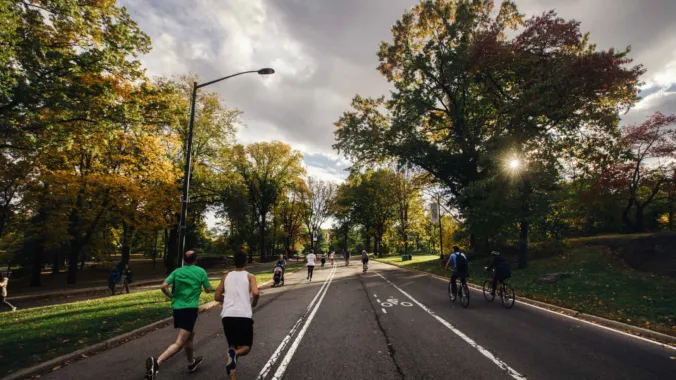 runners and bicyclists in park