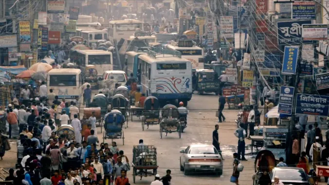 busy street with cars and pedestrians in India