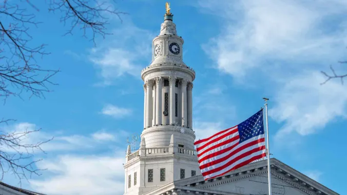 american flag with government building in background for urban planning course
