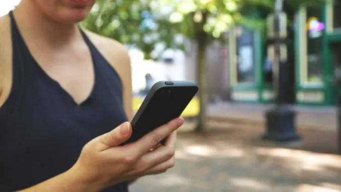 women holding mobile phone