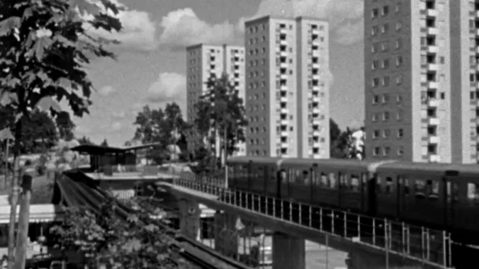 European city with train and buildings in black and white
