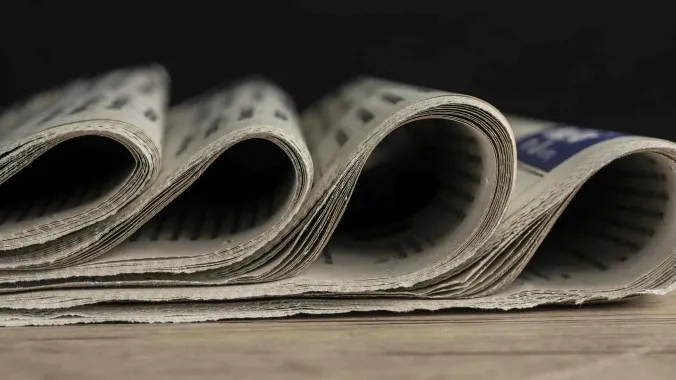 closeup of newspapers for writing press release course