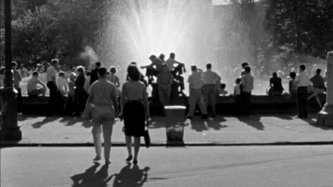 large city fountain surrounded by people
