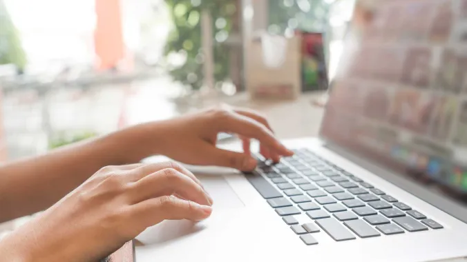 hands typing on a laptop