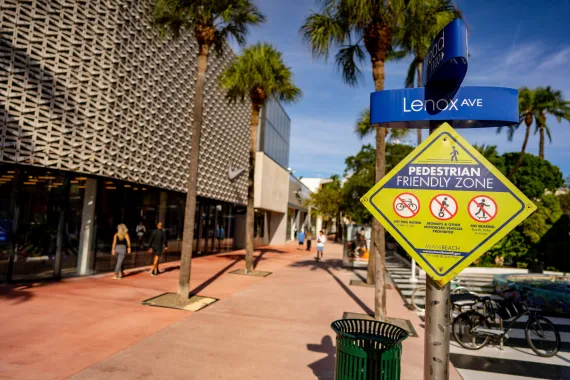 Image photo of Miami Beach Florida with Pedestrian Friendly Zone yellow sign attached to the Lenox Ave street sign