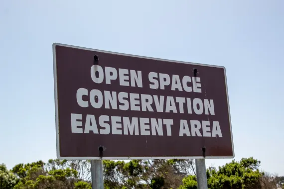 Image of a sign saying open space conservation easement area
