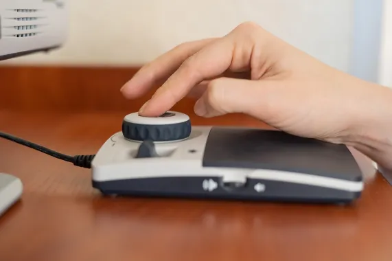 Photo of a computer user using an accessibility friendly scroller for browsing