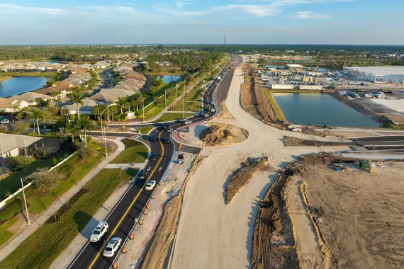 Bird-eye view of a freeway in constructions alongside a housing district