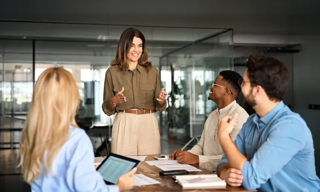 A women giving a presentation in front of her coworkers