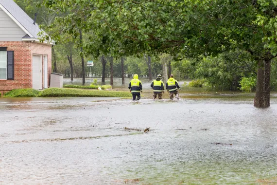 emergency workers in flooded neighborhood