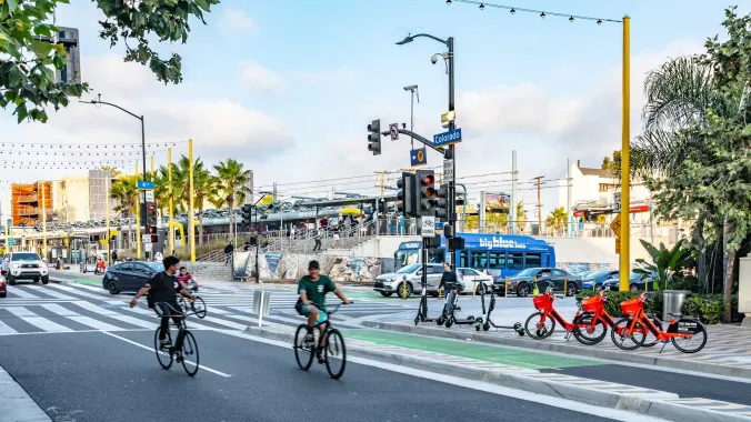 bicyclists with city bus in background in santa monica