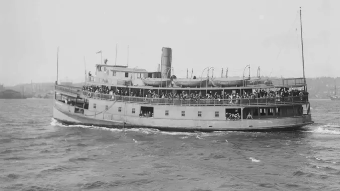 vintage photo of a boat with migrants near ellis island
