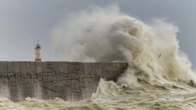 Waves impact breakwater