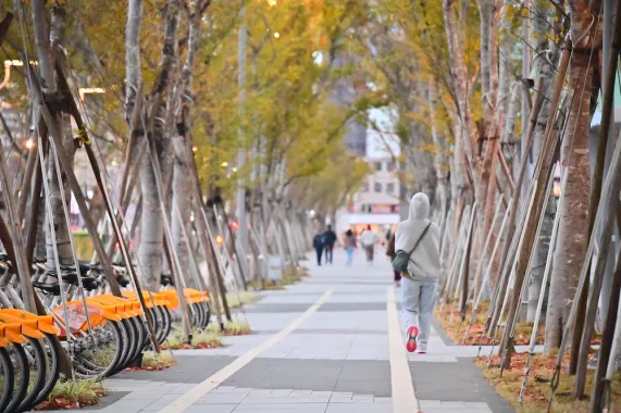 pedestrian on path next to bikeshare