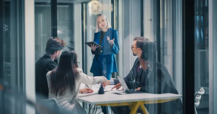 A woman leading an office meeting.