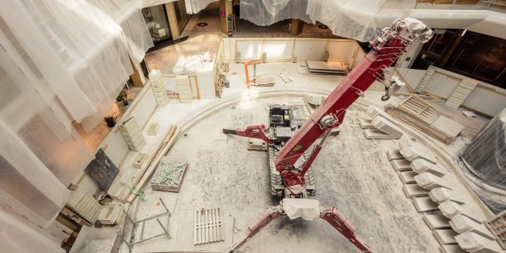 Construction inside a large two-story mall.