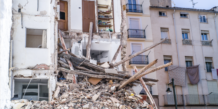 A crumbling residential building with collapsed floors