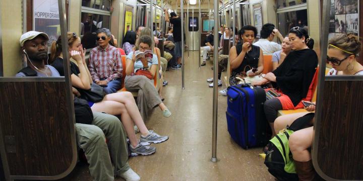 people sitting inside a New York subway car
