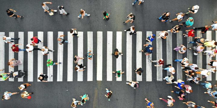 downward view of crowd crossing intersection