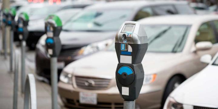 row of cars and parking meters