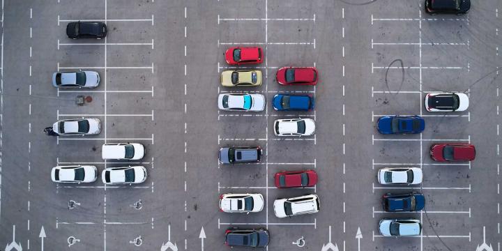 aerial view of a large outdoor parking lot with cars