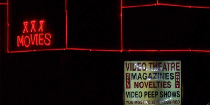 adult store exterior with neon signs