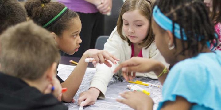 kids viewing map on table