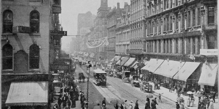 buildings, cars, people on Halsted Street in Chicago in 1900