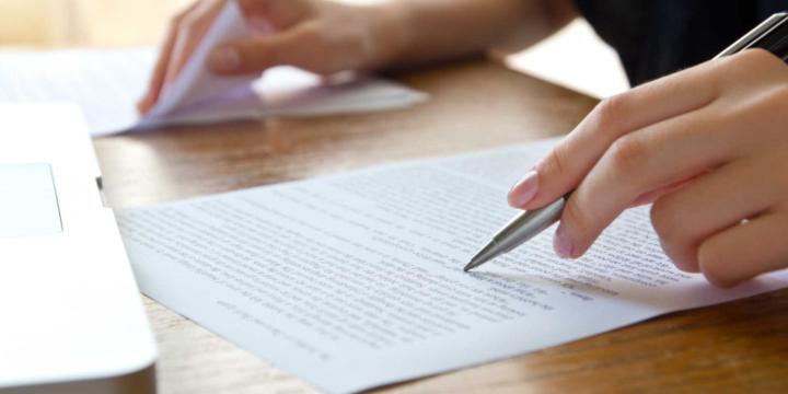 closeup of hands editing documents