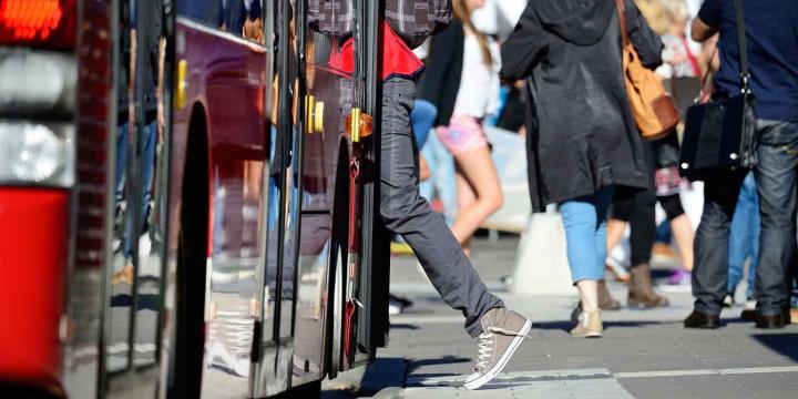 person getting on bus for urban planning course