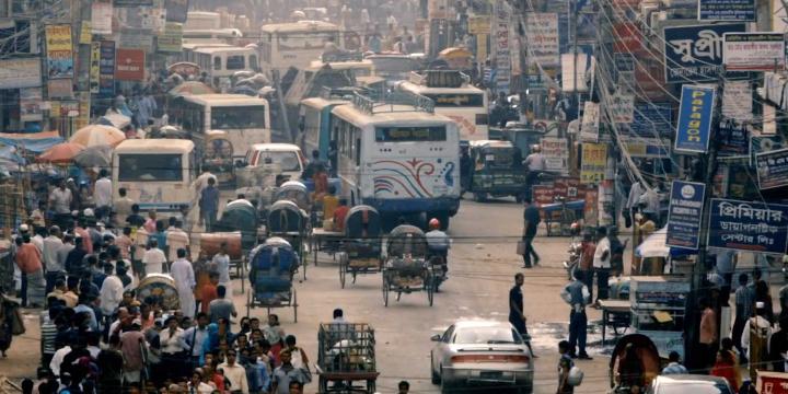 busy street with cars and pedestrians in India