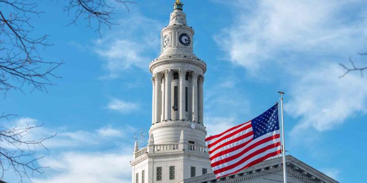 american flag with government building in background for urban planning course