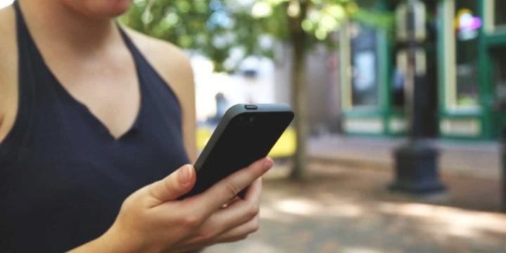 women holding mobile phone