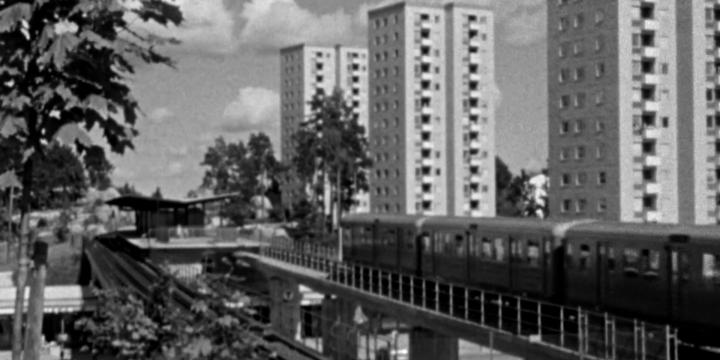 European city with train and buildings in black and white