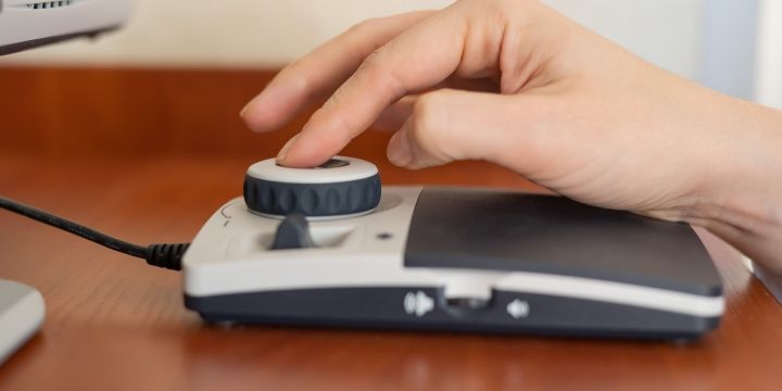 Photo of a computer user using an accessibility friendly scroller for browsing
