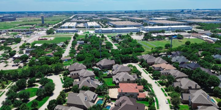 Image of a suburban area skyline birdeye view with houses, commercial buildings, and greenery