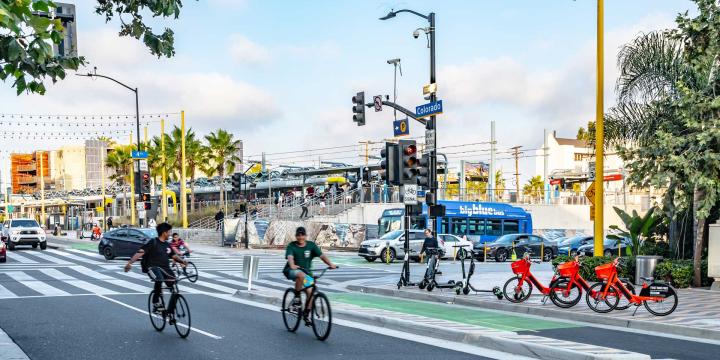 bicyclists with city bus in background in santa monica